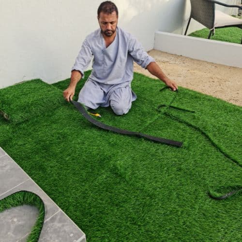Artificial grass being laid on site - Al Quoz, Dubai