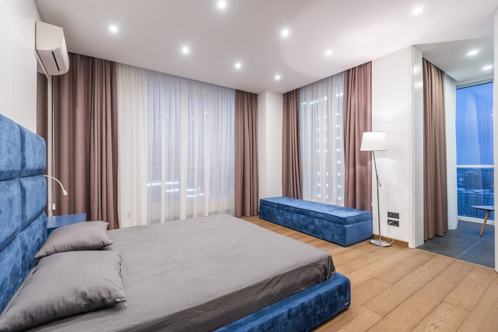 Bedroom with layered sheer and blackout curtains