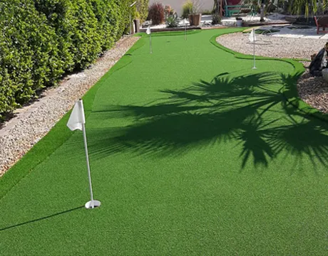 Close-up of flag hole on synthetic putting green - Putting greens, Dubai