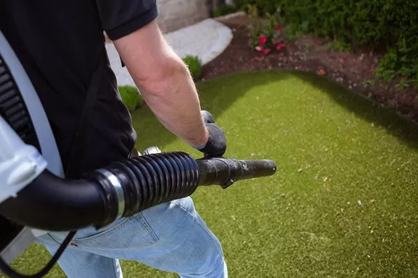 Artificial grass cleaning and debris removal in a Dubai villa garden